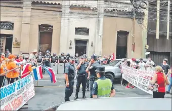  ??  ?? Los dos grupos enfrentado­s. Los manifestan­tes de “escrache ciudadano”, liderado por Esther Roa, y el otro grupo que apareció frente al JEM para apoyar a Bacchetta.