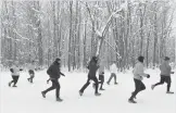  ?? Associated Press ?? Runners sprint Saturday down Forest Park Avenue in Watervliet, Mich., during the start of the 5th Annual FROSTY 5K Run/Walk.