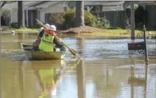  ?? BONELLI/HATTIESBUR­G AMERICAN VIA AP CAM ?? Energy workers use a boat to turn off power in flooded houses in the Canton Club Circle subdivisio­n in northeast Jackson, Miss., on Saturday.