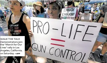  ?? —AFP ?? WALK THE TALK Demonstrat­ors join the “March for Our Lives” rally in Los Angeles, California, on Saturday.