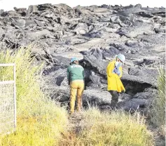  ??  ?? Geologists inspect a recent Lava flow from a fissure. — AFP photo