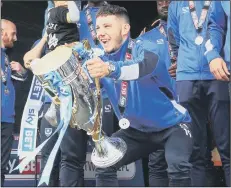  ??  ?? KEY ROLE Conor Chaplin lifts the League Two title trophy