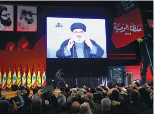 ?? (Aziz Taher/Reuters) ?? HEZBOLLAH CHIEF Hassan Nasrallah addresses supporters in Beirut via video on Friday.