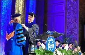  ?? Maddie Aiken/Post-Gazette ?? Louis Cestello, the current chairman of Pitt’s board of trustees, gives a medallion to Pitt Chancellor Joan Gabel during her installati­on on Friday at Carnegie Music Hall in Oakland.