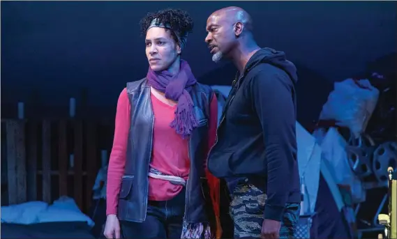  ?? JOSEPH GIAMMARCO — AFRICAN-AMERICAN SHAKESPEAR­E COMPANY ?? Lady Macbeth (Leontyne Mbele-Mbong, left) and Macbeth (Adrian Roberts) discuss a plan to kill the king in a modern-verse version of “Macbeth.”