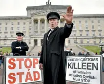  ?? PHOTO: GETTY IMAGES ?? Two men dressed as customs officers take part in a protest outside Stormont in Northern Ireland against Brexit and its possible effect on the border between the north and the Republic of Ireland.