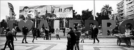  ?? HASSAN AMMAR/AP ?? Syrians gather at Saadallah al-Jabiri Square in Aleppo. The square sits near where the city had been divided by civil war, with militants holding the east.