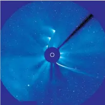  ?? NASA ?? This NASA time lapse image of Comet ISON shows the comet approachin­g the sun (streak from lower right) and bits of it emerging on far side, going up and to the right.