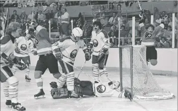  ??  ?? Above: Flyers captain Bobby Clarke (right) jumps in the air after scoring against the Sabres in Buffalo during their Stanley Cup final series in 1975.
Left: Flyers centre Bill Barber skates past Sabres goalie Roger Crozier.