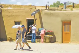  ?? RICK ROMANCITO FOR THE TAOS NEWS ?? Vendors in Taos Pueblo welcomed back visitors Saturday. Securing enough staff to handle the expected influx of tourists who come in droves each summer was a prerequisi­te for the reopening, according to the tribe.