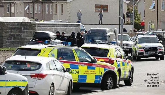  ??  ?? Stand-off: Armed gardaí, also below, at the scene