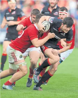  ?? Photograph: Fotosport ?? Munster flanker Conor Oliver tries to halt Edinburgh’s Blair Kinghorn