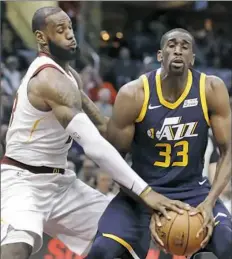  ?? Tony Dejak/Associated Press ?? LeBron James gets his hand on the ball as Utah’s Ekpe Udoh attempted to go around him Saturday night in Cleveland.
