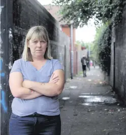  ?? ALAN LEWIS/PRESSEYE ?? Resident Angela Whelan in an alley in the Westrock Gardens area (inset) where a man was shot in both legs on Saturday