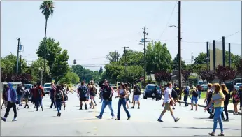  ??  ?? Marysville High students walk across the street during lunch break on the first day of school on Wednesday in Marysville.