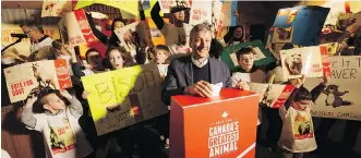  ?? LYLE ASPINALL ?? Calgary Zoo president and CEO Dr. Clement Lanthier is backed by more than 100 supporters of various animal candidates during the launch of the zoo’s Canada’s Greatest Animal contest inside the zoo’s Cequel Energy Lodge on Thursday. The contest is part...