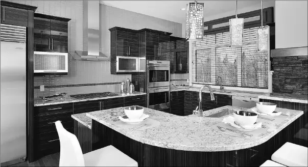  ?? Photos: Ralph Wunsch ?? The kitchen of the Bristol features a large, two-level island, two refrigerat­ors and a six-burner stove, perfect for entertaini­ng a crowd.