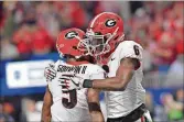  ?? HYOSUB SHIN / HSHIN@AJC.COM ?? Bulldogs Terry Godwin and Javon Wims sport the famous “G” on their helmets. Which came first, the UGA “G” or the Green Bay Packers’ “G?”