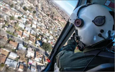  ?? Austin Dave/The Signal (See additional photos at signalscv.com) ?? Tactical Flight Deputy Misty Trejo flies over the Santa Clarita Valley in a Eurocopter AS350 B2s on Monday. Trejo is part of the Aero Bureau of the Los Angeles County Sheriff’s Department. For a video story on the bureau, visit SignalSCV.com.