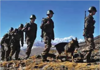  ??  ?? Chinese troops patrolling near the LAC in the Himalayas.