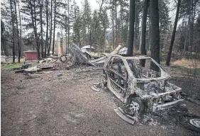  ?? DARRYL DYCK THE CANADIAN PRESS FILE PHOTO ?? The remains of a vehicle and a home that were destroyed by a wildfire in Monte Lake, B.C., in 2021. The developing “National Adaptation Strategy” includes a pledge that, by 2030, Canadians affected by climate disasters like floods or wildfires would no longer be displaced.