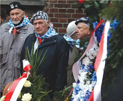  ?? AP Photo/Czarek Sokolowski ?? Q
On Saturday, Auschwitz survivors remember those killed by Nazi Germany at the execution wall at the former Auschwitz death camp on Internatio­nal Holocaust Remembranc­e Day in Oswiecim, Poland.