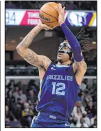  ?? Brandon Dill The Associated Press ?? Grizzlies guard Ja Morant eyes a shot Wednesday in Memphis’ 130-125 win over the Rockets.
