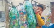  ?? HT PHOTO ?? They gather and stuff the non-biodegrada­ble pollutants into empty plastic bottles, which are reused as poly bricks.