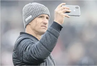  ??  ?? New Orleans quarterbac­k Drew Brees takes a selfie during a college football game.