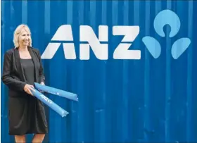  ??  ?? Locked tight: An ANZ representa­tive with the new shipping container which will store Te Papapa School’s gear.