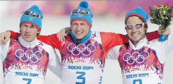  ?? MATTHIAS SCHRADER/THE ASSOCIATED PRESS/FILES ?? From left, Maxim Vylegzhani­n, Alexander Legkov and Ilia Chernousov celebrate at the 2014 Games. Vylegzhani­n and Legkov were stripped of their medals in Sochi but can race in World Cup events for the time being.