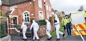  ??  ?? Crime scene: Forensics officers at the Stourbridg­e home yesterday