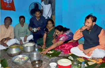  ?? — PTI ?? Union HRD minister Prakash Javadekar has lunch at the residence of a BJP supporter during his visit to a slum in Bhubaneswa­r on Sunday.