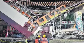  ?? AFP ?? Rescue workers gather at the site where an elevated train collapsed on a road in Mexico City.