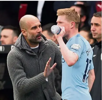  ?? — Reuters ?? Listen closely: Manchester City manager Pep Guardiola (left) giving instructio­ns to midfielder Kevin De Bruyne during the Premier League match at Selhurst Park on Sunday.