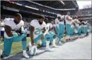  ?? STEPHEN BRASHEAR — THE ASSOCIATED PRESS ?? In this Sept. 11, 2017 file photo, from left, Miami Dolphins’ Jelani Jenkins, Arian Foster, Michael Thomas, and Kenny Stills, kneel during the singing of the national anthem before an NFL football game against the Seattle Seahawks in Seattle.