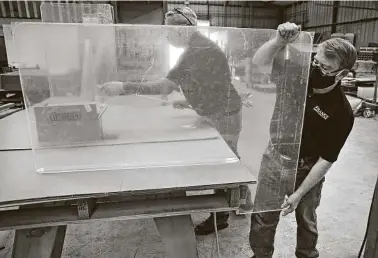  ?? Bob Owen / Staff photograph­er ?? Owner James Franks, right, has added plexiglass shields to Franks Manufactur­ing’s product line. Franks says the company makes 600 shields per day.