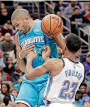  ?? [AP PHOTO] ?? In the Thunder’s win Saturday against the Hornets, Oklahoma City rookie Terrance Ferguson, right, was asked to defend Charlotte guard Nicolas Batum, a 10-year NBA veteran.