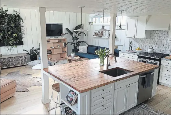  ??  ?? With 800 square feet to work with, efficient use of space is essential. Extra storage is built underneath the butcher-block island and stools tuck in under the countertop.