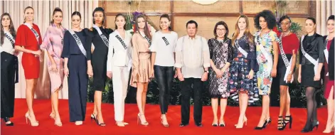  ??  ?? Miss Universe contestant­s pose for photos with Philippine President Rodrigo Duterte (centre) and Philippine Tourism Secretary Wanda Corazon Teo (sixth right) during a courtesy call at Malacanang Palace in Manila. — AFP photo