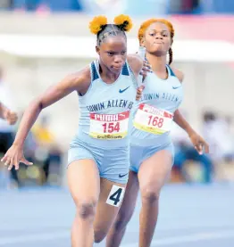  ?? FILE ?? Edwin Allen High’s Tia Clayton (left) is off and running on the final leg of the Class One 4x100m at the 2022 ISSA/GraceKenne­dy Boys and Girls’ Championsh­ips at the National Stadium.