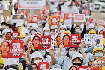  ?? — AFP photo ?? Protesters hold up placards demanding the release of detained Suu Kyi during a demonstrat­ion against the military coup in Yangon.