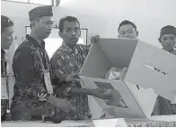  ?? PUGUH SUJIATMIKO/JAWA POS ?? LAKSANAKAN PUTUSAN MK: Hitung ulang di kantor KPU Surabaya akhirnya memenangka­n Agoeng Prasodjo.