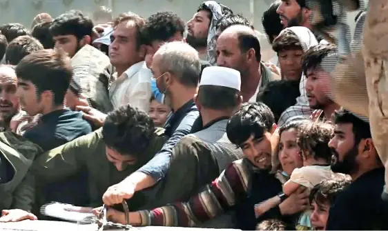  ??  ?? TIME RUNNING OUT: Desperate Afghans are trying to get on a flight out of the country as officials warn that Kabul airport could fall to the Taliban within days