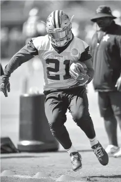  ?? Associated Press ?? Dallas Cowboys running back Ezekiel Elliott runs a drill during NFL football training camp Tuesday in Oxnard, Calif.