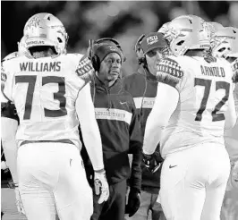  ?? PAUL SANCYA/AP ?? Florida State coach Willie Taggart, center, is urging his players to stay sharp and push to play up to their potential against Boston College.