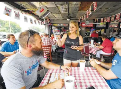  ?? STAFF FILE PHOTO BY DAN HENRY ?? Champy’s server Mandy Veasey takes the order of Nashville residents Kendall Daniel, left, and Jeremy Quarles as they visit the M.L. King Boulevard restaurant in 2015.