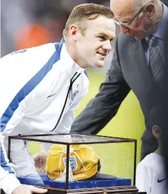  ??  ?? England’s striker Wayne Rooney (L) is awarded his 100th cap by Bobby Charlton ahead of the Euro 2016 Qualifier,Group E football match between England and Slovenia atWembley in north London on November 15, 2014. - AFP photo