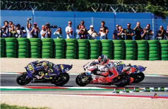  ??  ?? ABOVE: Petrucci (9) had the speed but he couldn’t pass Rossi (46) LEFT: Andrea Dovisioso celebrates a well-deserved victory