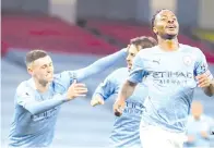  ??  ?? Sterling (right) celebrates scoring the opening goal during the English Premier League football match between Manchester City and Arsenal at the Etihad Stadium in Manchester, north west England. - AFP photo